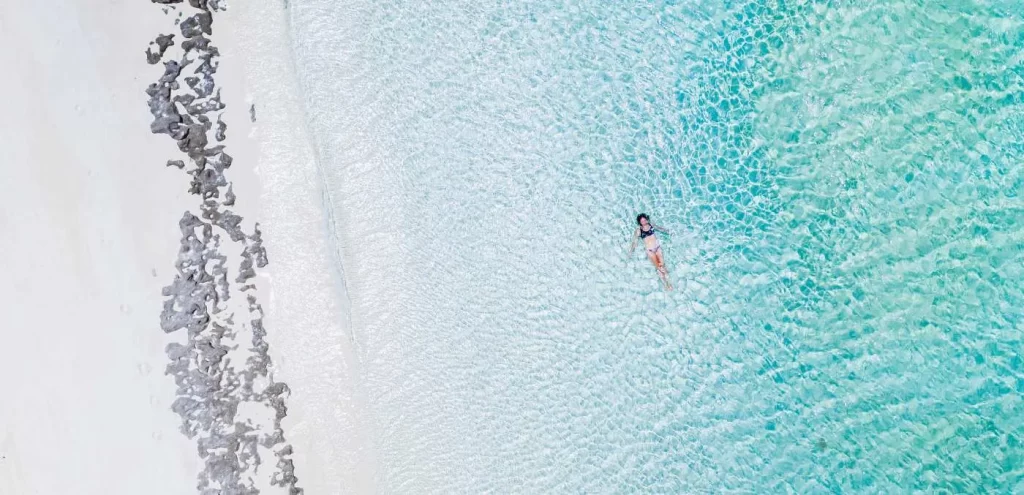 Person floating in shallow water close to shore - TrueNorth_ROWLEY_SHOALS