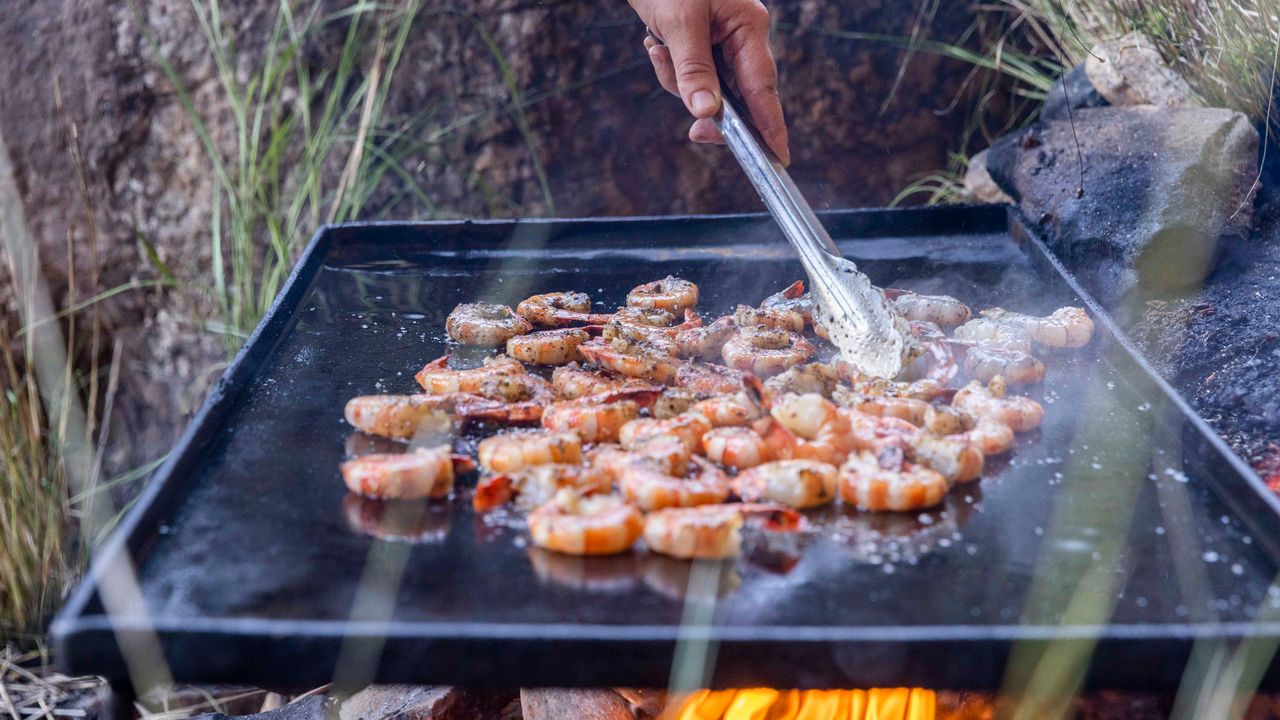 Grilling seasoned shrimp, part of True North's modern Australian cuisine