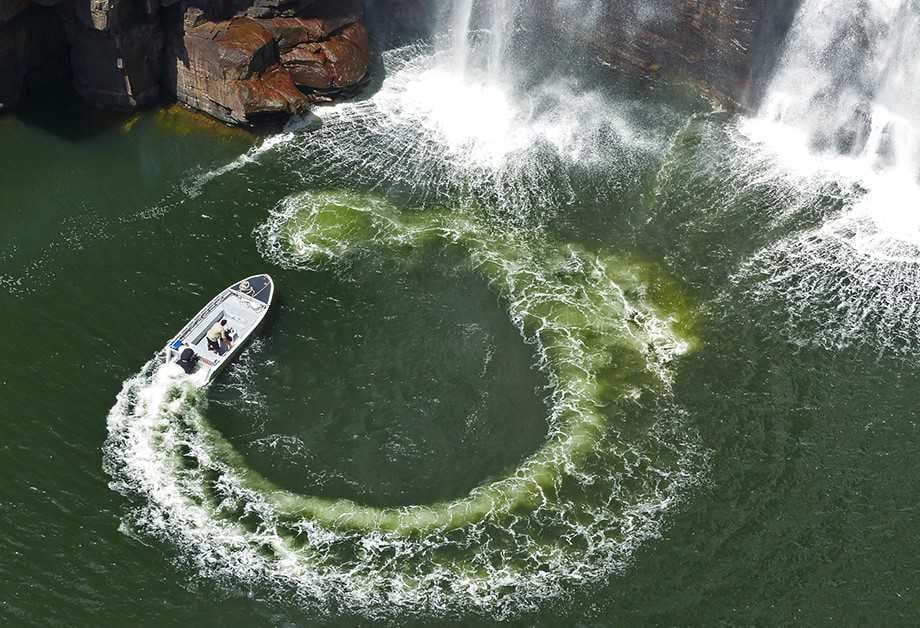 Adventure boat circling waterfall on True North cruise ship vs yacht shore excursion in Kimberley