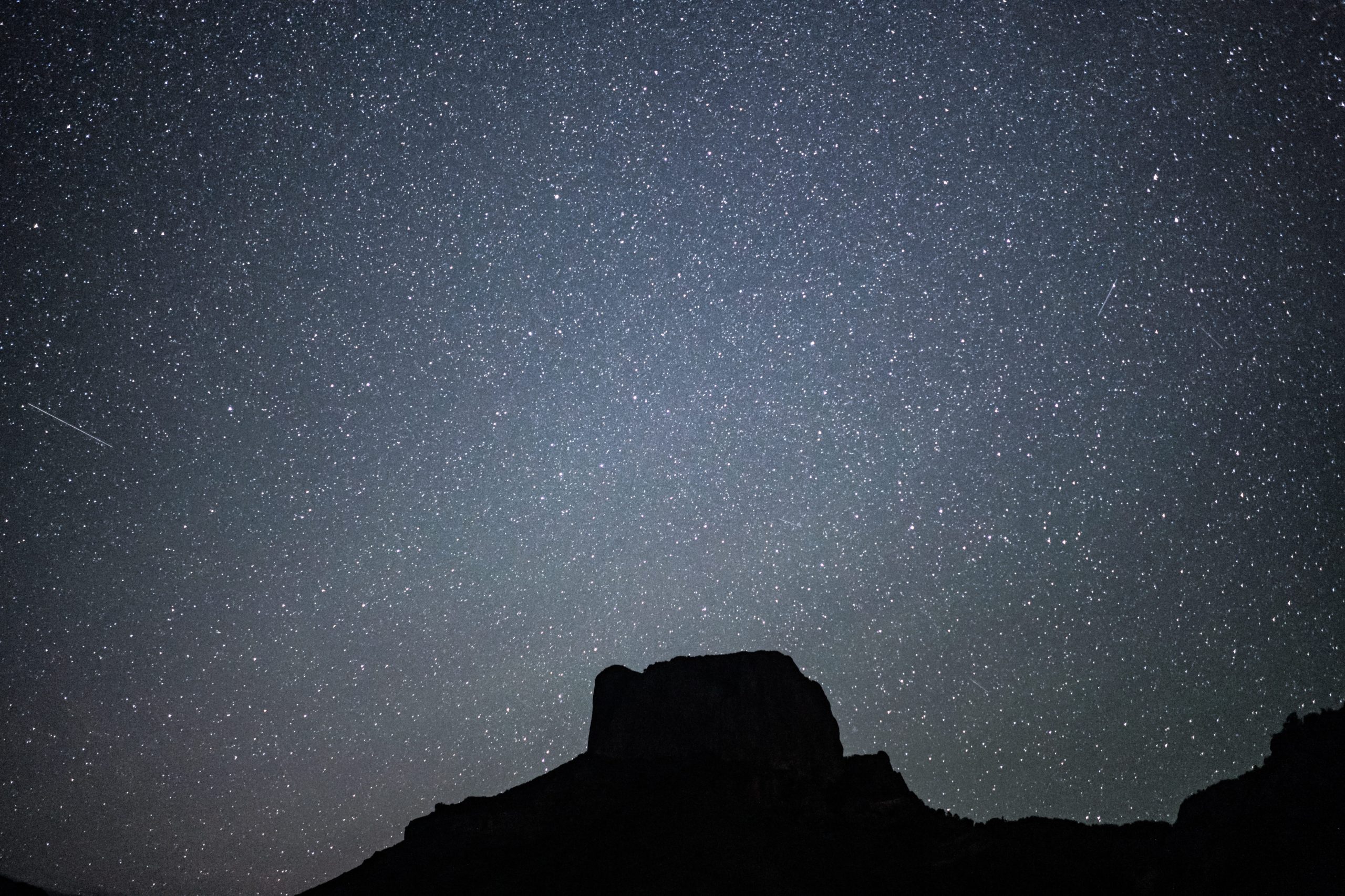 Ancient rock formations silhouetted against a star-filled sky on a Kimberley stargazing adventure.