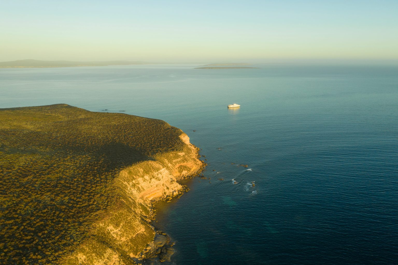 True North expedition cruise ship off the rugged South Australian coastline near the Eyre Peninsula during an Adelaide cruise.